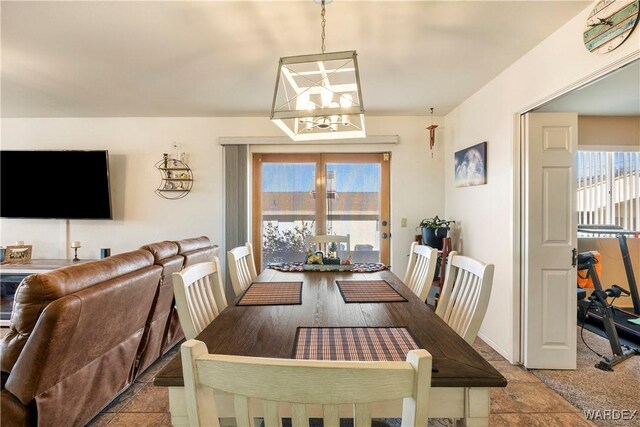 dining room with baseboards, a notable chandelier, and french doors