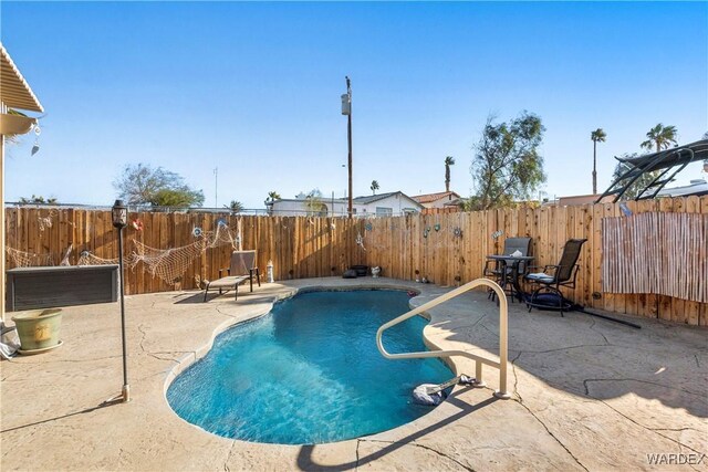 view of swimming pool with a fenced backyard, a fenced in pool, and a patio