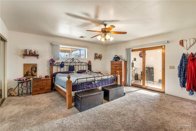 bedroom with light carpet, access to exterior, visible vents, and a ceiling fan