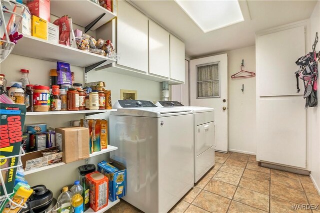 laundry room with cabinet space and washing machine and dryer