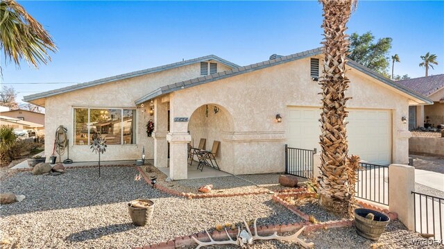 view of front of house with an attached garage and stucco siding