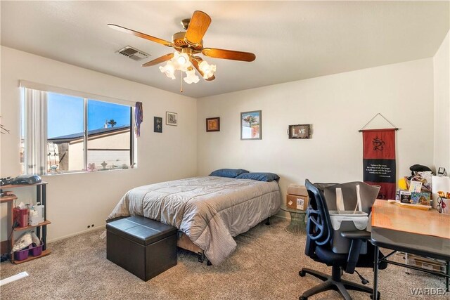 carpeted bedroom with visible vents, ceiling fan, and baseboards