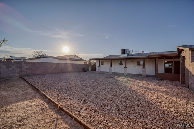 exterior space with a fenced backyard and central air condition unit