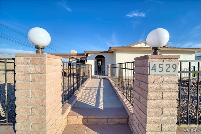 view of front of property featuring fence and stucco siding