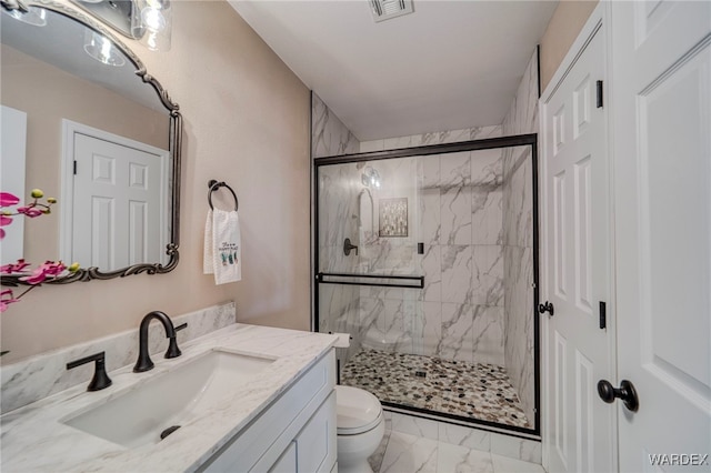 full bathroom featuring a marble finish shower, visible vents, toilet, marble finish floor, and vanity