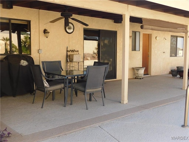 view of patio featuring outdoor dining area and a ceiling fan