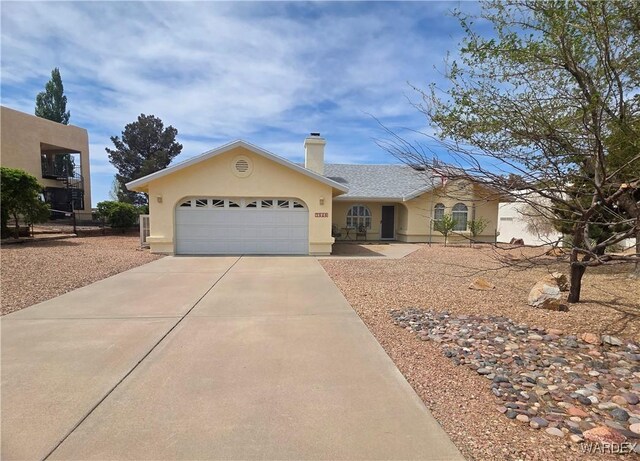 ranch-style house featuring an attached garage, a chimney, concrete driveway, and stucco siding
