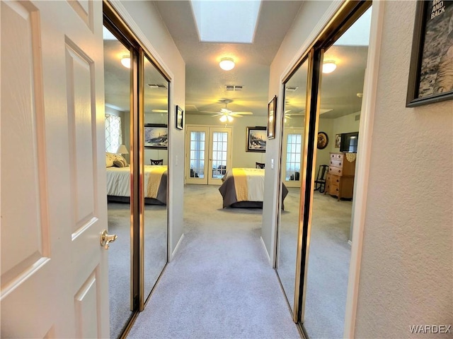 corridor featuring visible vents and carpet