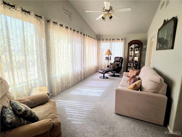 interior space with carpet floors, a ceiling fan, and lofted ceiling