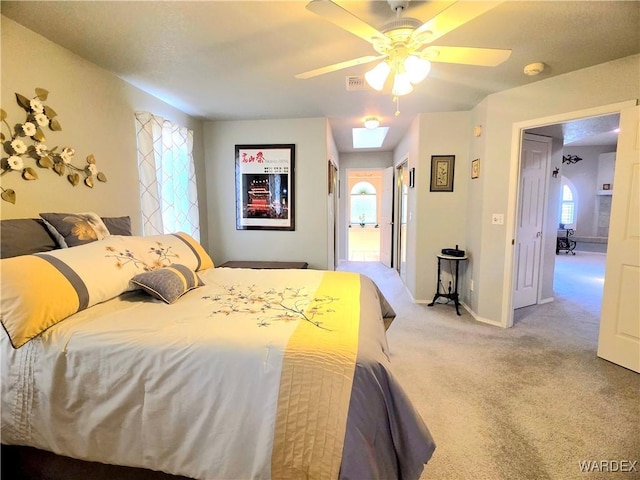 bedroom with baseboards, ceiling fan, and light carpet