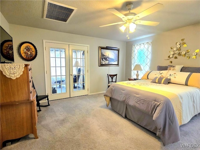 bedroom with french doors, multiple windows, visible vents, and carpet floors