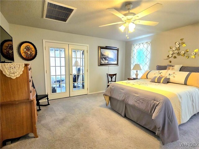 bedroom with french doors, multiple windows, visible vents, and carpet floors