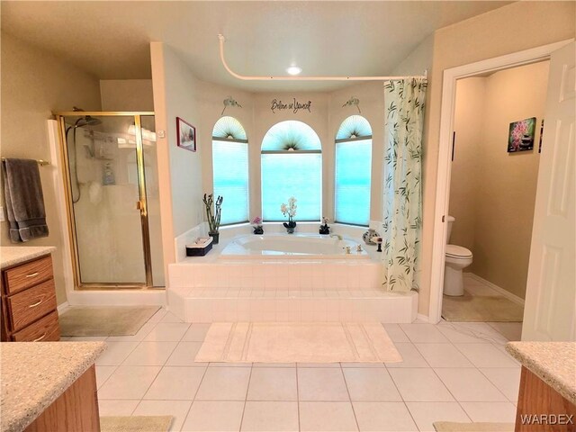 bathroom with tile patterned flooring, a stall shower, and a garden tub