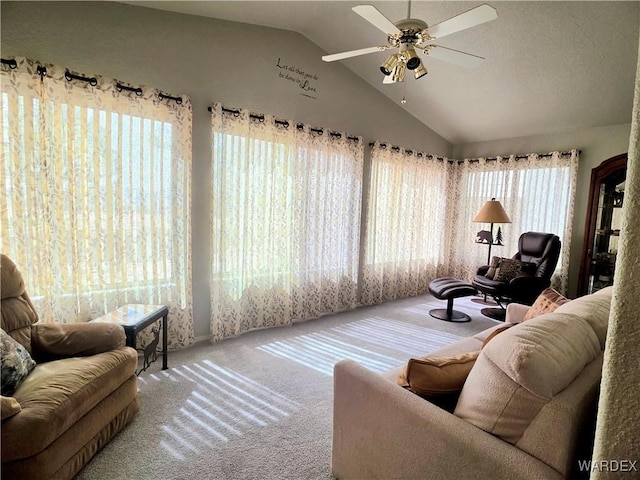 carpeted living area featuring ceiling fan and vaulted ceiling