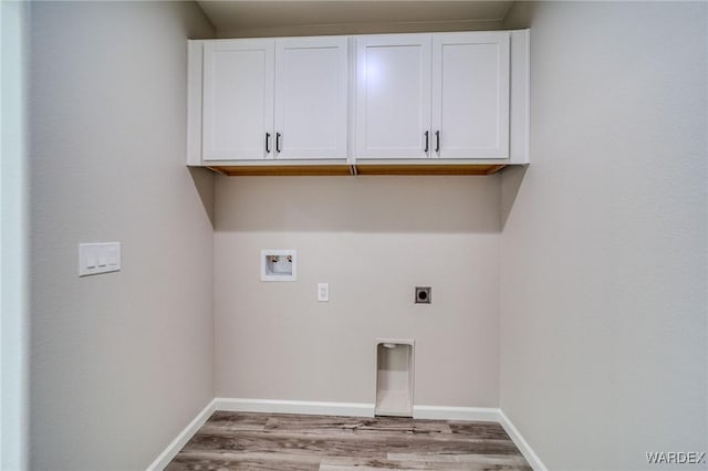 washroom with light wood-style flooring, hookup for an electric dryer, washer hookup, baseboards, and cabinet space