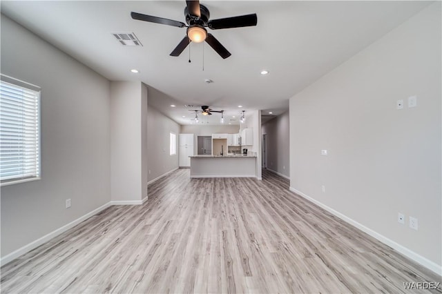 unfurnished living room featuring baseboards, visible vents, a ceiling fan, light wood-style floors, and recessed lighting