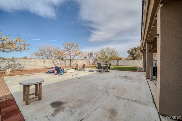 view of patio / terrace featuring an outdoor fire pit and a fenced backyard