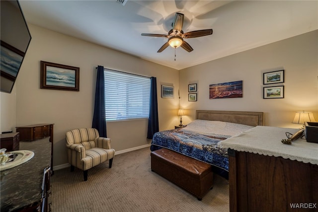 bedroom featuring ceiling fan, baseboards, and light colored carpet