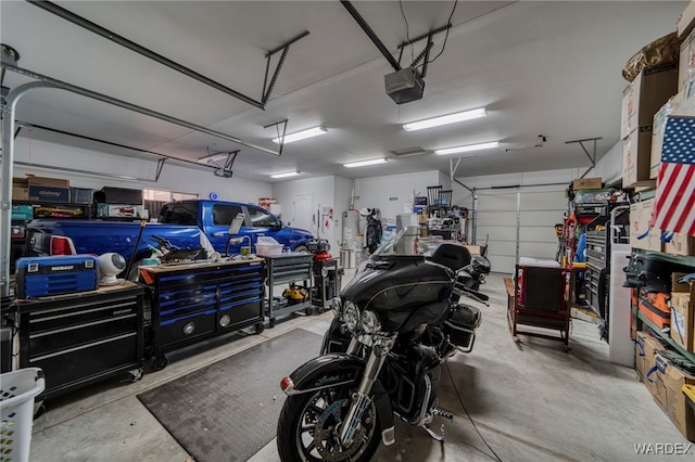 garage with a workshop area and a garage door opener