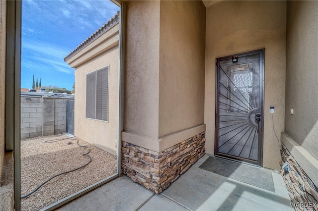 view of exterior entry with stucco siding