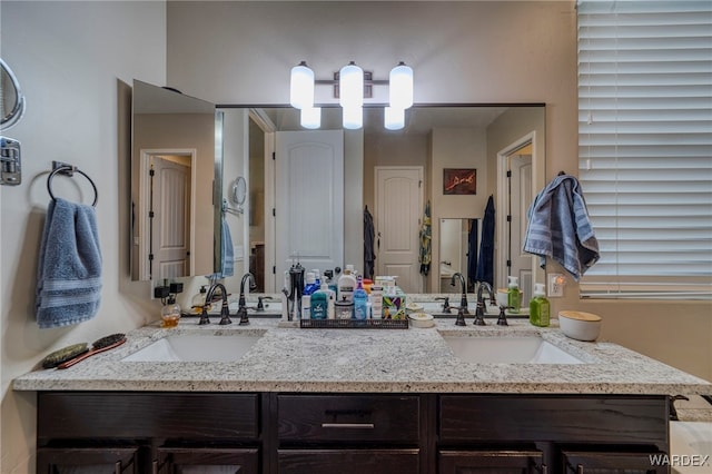 bathroom with double vanity and a sink