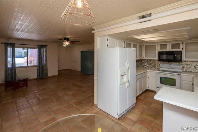 kitchen with light countertops, visible vents, a ceiling fan, white appliances, and decorative backsplash