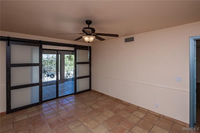 spare room with visible vents and ceiling fan