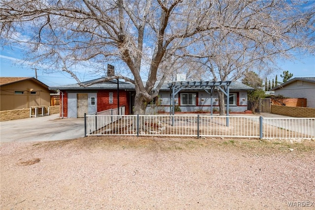 ranch-style home featuring driveway, a chimney, and fence