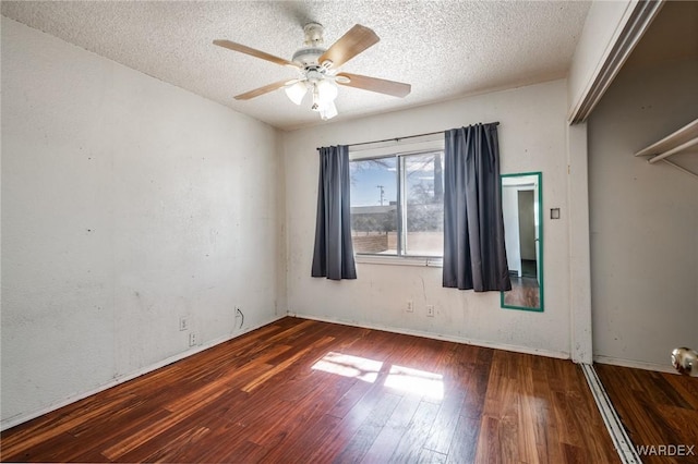 unfurnished room featuring ceiling fan, a textured ceiling, and wood finished floors