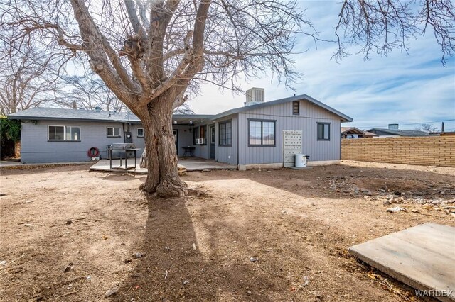 back of house featuring a patio area and fence