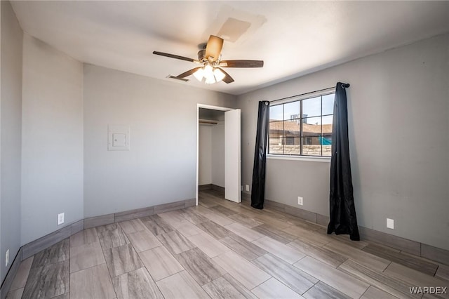 unfurnished bedroom featuring a closet, a ceiling fan, and baseboards