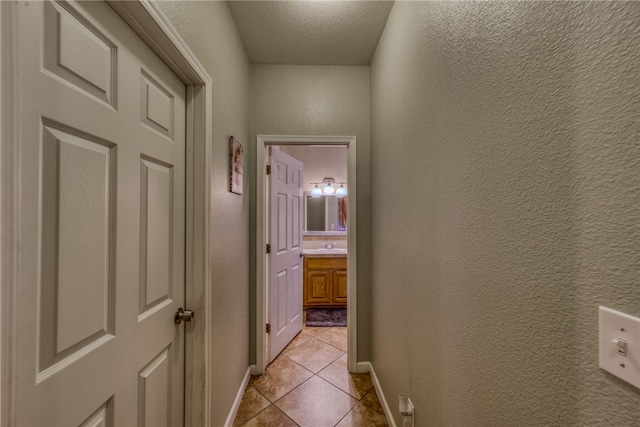 1919 Richardo Ave, Bullhead City, AZ 86442 - hall with a textured wall, light tile patterned floors, baseboards, and a textured ceiling