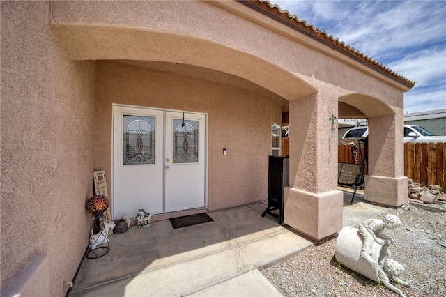 1919 Richardo Ave, Bullhead City, AZ 86442 - doorway to property with stucco siding, fence, and a patio area