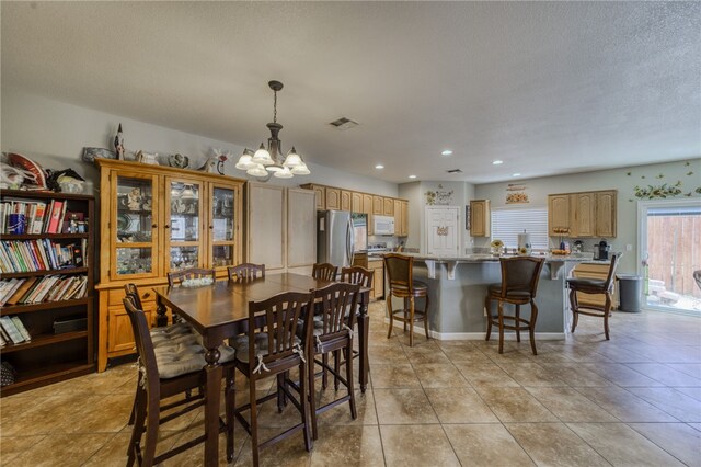 1919 Richardo Ave, Bullhead City, AZ 86442 - dining space with a chandelier, light tile patterned flooring, recessed lighting, and a textured ceiling