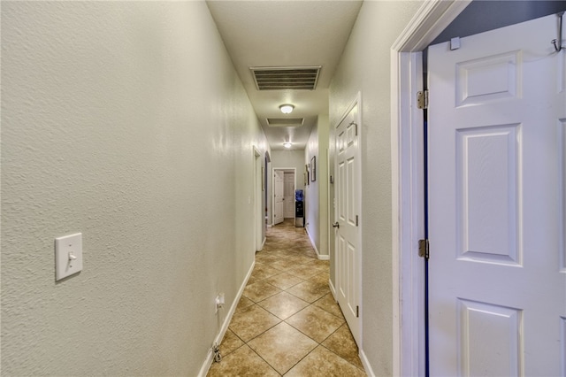 1919 Richardo Ave, Bullhead City, AZ 86442 - corridor featuring light tile patterned floors, a textured wall, baseboards, and attic access