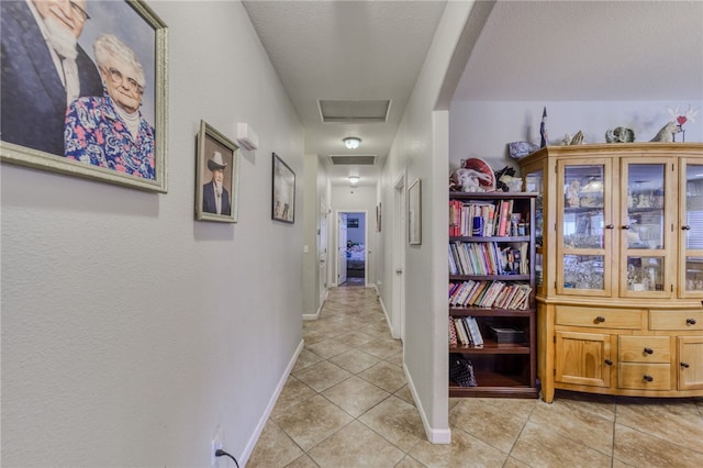1919 Richardo Ave, Bullhead City, AZ 86442 - hallway with light tile patterned flooring, attic access, and baseboards