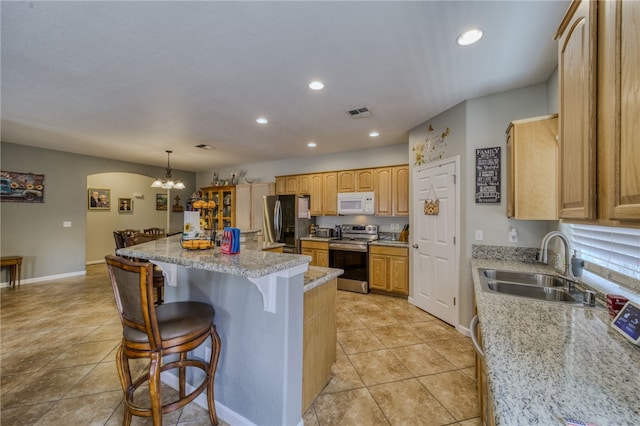 1919 Richardo Ave, Bullhead City, AZ 86442 - kitchen with stainless steel appliances, a sink, a breakfast bar area, recessed lighting, and a kitchen island