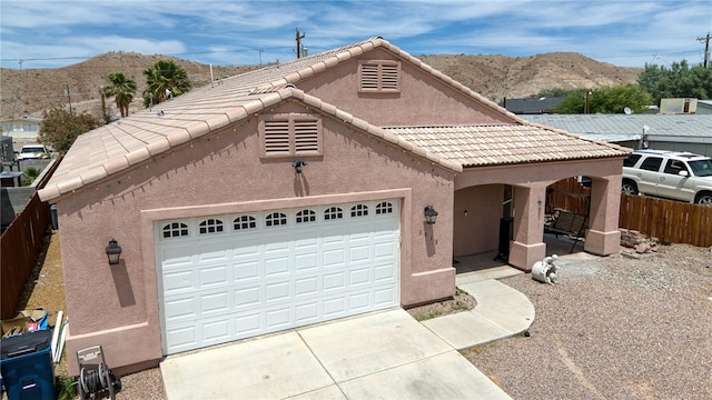 1919 Richardo Ave, Bullhead City, AZ 86442 - view of front of property with stucco siding, a mountain view, fence, a tiled roof, and driveway