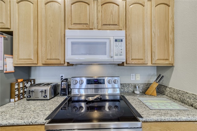 1919 Richardo Ave, Bullhead City, AZ 86442 - kitchen featuring white microwave, stainless steel range with electric cooktop, and light brown cabinetry
