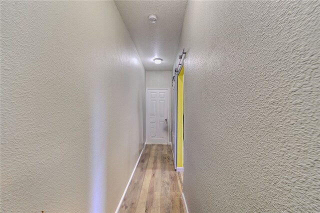 1919 Richardo Ave, Bullhead City, AZ 86442 - hall featuring a textured wall, wood finished floors, and baseboards