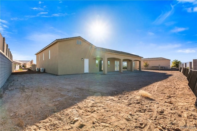 exterior space with fence and stucco siding