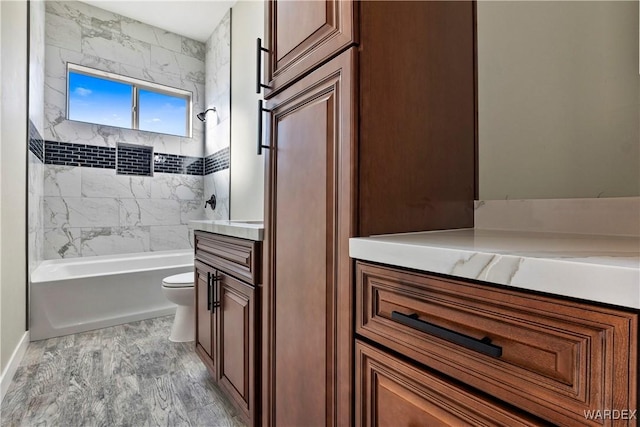 full bath featuring toilet, tub / shower combination, and vanity