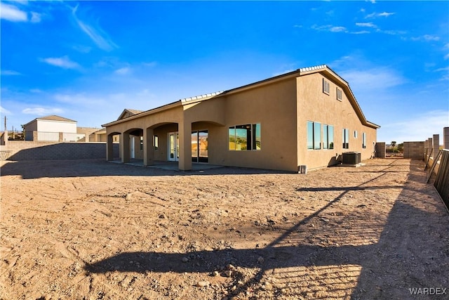 exterior space featuring a fenced backyard, central AC, and stucco siding