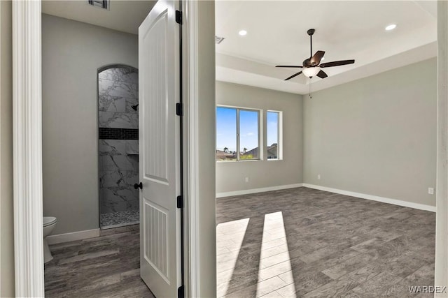 interior space featuring a ceiling fan, baseboards, dark wood-style flooring, and recessed lighting