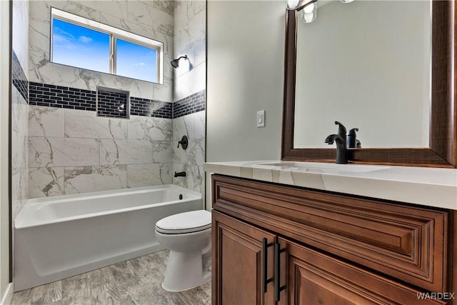 bathroom featuring  shower combination, vanity, and toilet