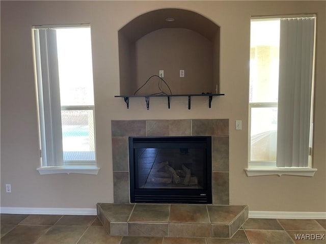 interior details with a fireplace and baseboards