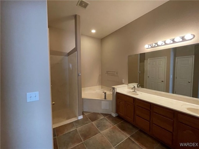 full bath with double vanity, visible vents, a garden tub, tile patterned flooring, and a sink