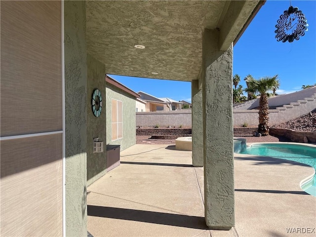 view of patio / terrace with a fenced in pool and fence