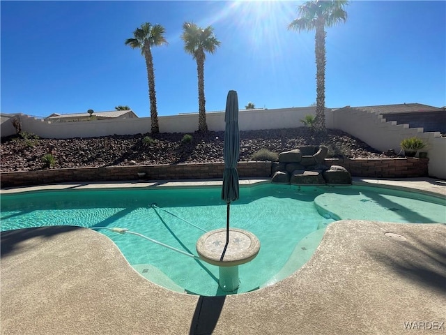 view of swimming pool with fence and a fenced in pool