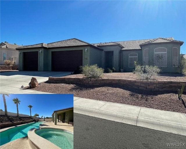 view of front of property featuring driveway, an attached garage, a pool with connected hot tub, and stucco siding